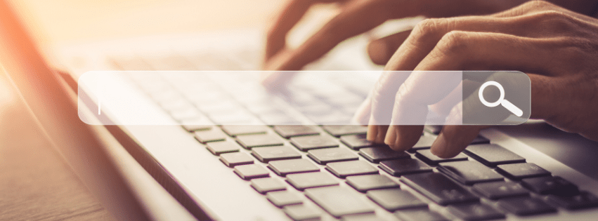 fingers typing on a computer, with a internet search box overlay